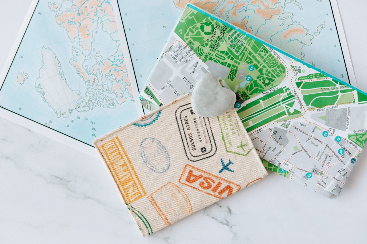 Services An overhead view of a passport holder on top of maps, symbolizing travel and exploration.